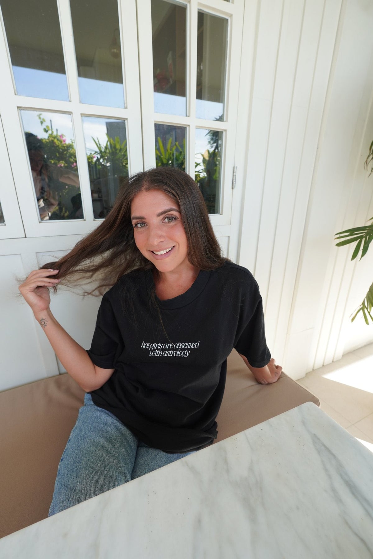 amina, founder, wearing the signature t-shirt