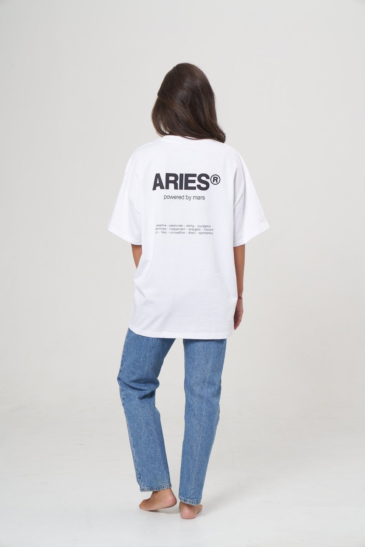 aries in white with jeans